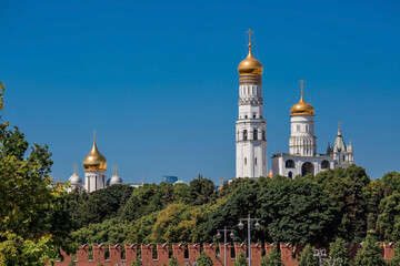 Fototapeta na wymiar Moscow, Russia, June 2023: View of the bell of Ivan the Great in the Moscow Kremlin behind the Kremlin wall on a sunny summer day.