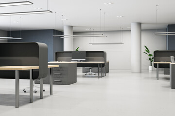 Modern coworking office interior with furniture, empty computer monitors and concrete flooring. 3D Rendering.