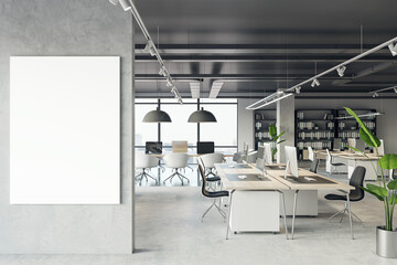 Front view of blank white isolated poster on a light grey wall at the entrance to modern loft office interior with concrete floor and window with city view. 3D Rendering, mockup, template background