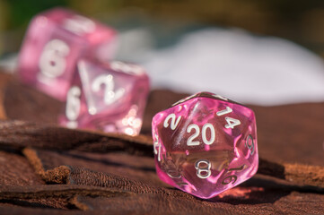 close-up of a Transparent pink RPG dice