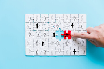 Human resources management and recruitment business build team concept. Image of tangram puzzle blocks with people icons over wooden table ,human resources and management concept.