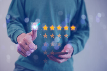 feedback and Customer service satisfaction survey concept.Businessman, customers show satisfaction by pressing star on five star bar in satisfaction on virtual touch screen