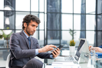 Businessman using his mobile phone in the office.