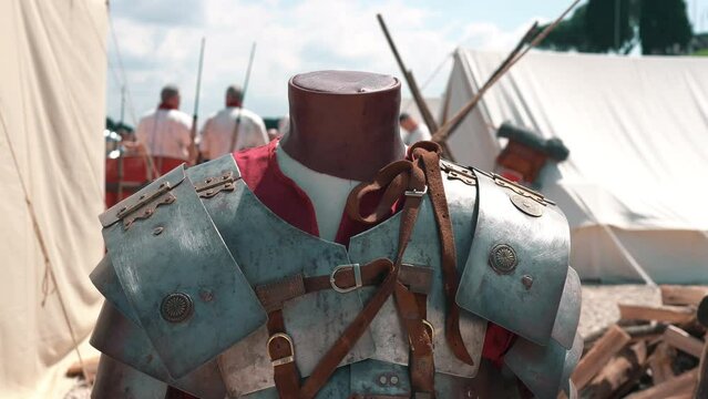 Armour equipment of Roman legionaries during the times of medieval battles, protective shields and helmets, spears and swords for struggle against the enemies. Military camp of Roman Empire units