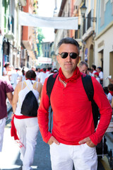 People doused with wine celebrate San Fermin festival in traditional white abd red clothing with red necktie in Pamplona, Navarra, Spain