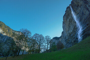 Beautiful views of waterfalls and rocky cliffs in the Interlaken village .