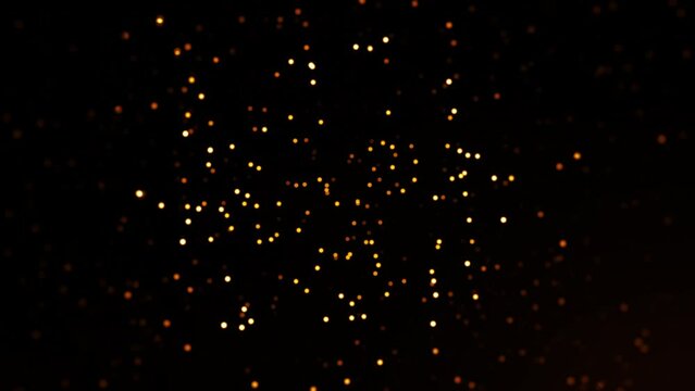 Abstract seamless loop animation glow orange particles  on black background. 4K 3D chaotic motion of glow particles orange  flying in the air