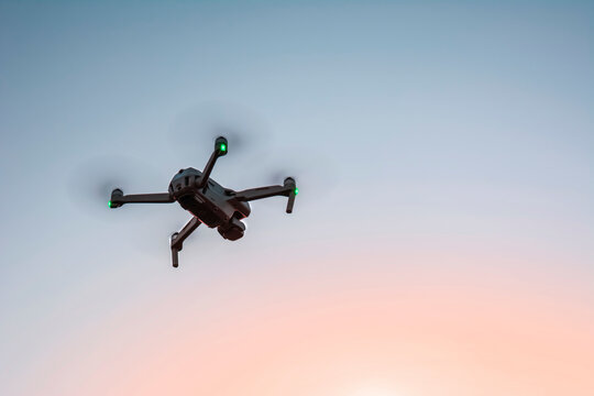 drone flying in the sky at sunset