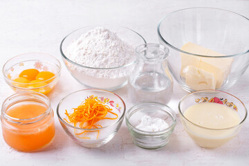 Ingredients for making chopped cake with lemon curd and buttercream on white table. Step by step recipe of the dessert