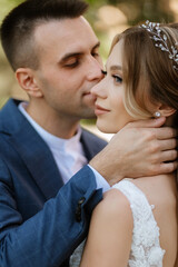 Fototapeta premium newlyweds walk in the city near old buildings