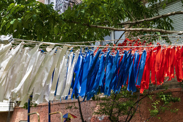 Colorful ribbons hanging on a clothesline in front of the house