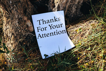 thanks for your attentions concept on white papers near trees