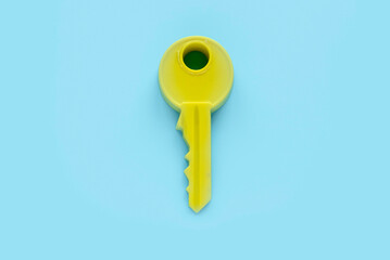 Yellow key isolated on a blue background.