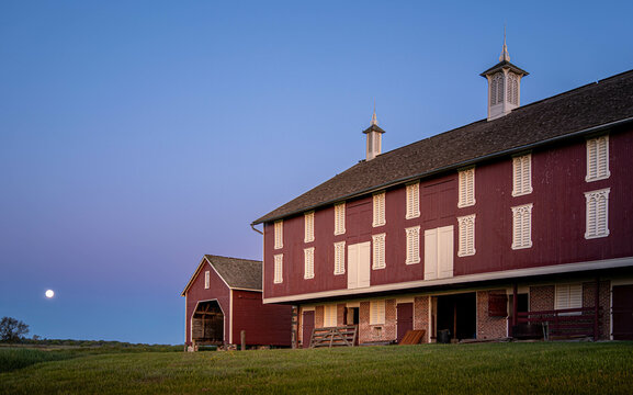 Red barn at Codori Farm in Gettysburg the Moon sets the purple morning sky