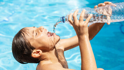 Outdoor boy have problem with heatwave in summer, young man drinking water to cool off during...