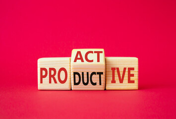 Proactive and Productive symbol. Wooden cubes with words Productive and Proactive. Beautiful red background. Business concept. Copy space