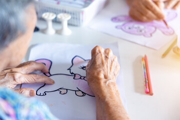 Elderly painting works of cartoon artwork as a hobby activity for exercise hand and brain.