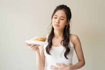 food intolerance concept, young women anxiety before eating bread worrying about gluten intolerance...