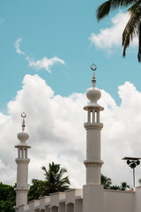 Fototapeta na wymiar Beautiful mosque minaret image with cloudy blue sky on the background, Eid Mubarak background