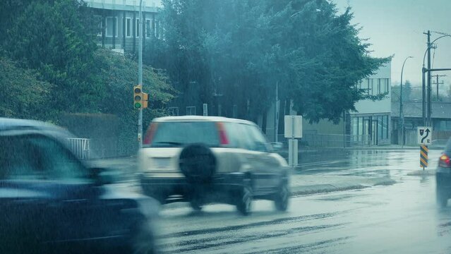 Heavy Rain On City Road With Passing Cars