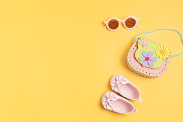 Flat lay with little girl fashion summer accessories, bag and sunglasses. Kids fashion, online store application, summer urban style for kids concept