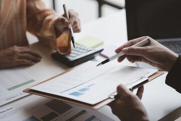 Atmosphere of a startup company meeting, business people are meeting together to summarize and plan investment finances, they are the founders of the company. Business administration concept.