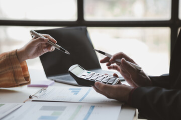 Atmosphere of a startup company meeting, business people are meeting together to summarize and plan investment finances, they are the founders of the company. Business administration concept.