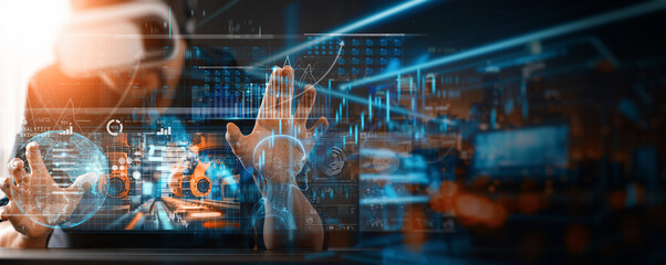 Engineer manager wearing virtual reality headset uses VR technology checking and control automation robot arms machine Welding robotics and digital manufacturing in intelligent factory industrial.