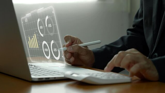Businessman working with laptop computer, showing chart and graph icons on virtual hologram digital screen interface. Big data analytics, BI business intelligence, investment and financial concept.