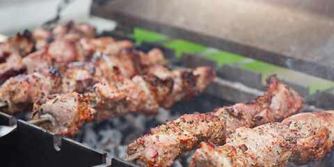 Pork is cooked in spices on the grill. Fried meat, shish kebab.