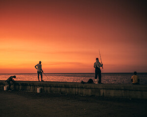 Fishermen working during sunset on Havana Malecón