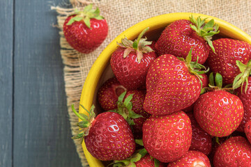 Fresh strawberry is on a dark wooden background