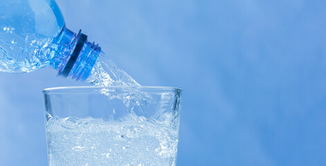 Horizontal banner with Fresh and cool water flowing from the bottle neck