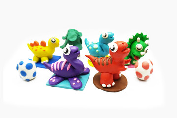 Obraz premium modeling clay, clay, dinosaur, animal, education, art, kid, white, colors, red, yellow, green, egg, tree, blue, purple