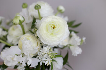 Bouquet of white flowers in female hands