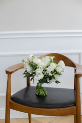 Wedding bouquet of white flowers on a background. Wooden chair