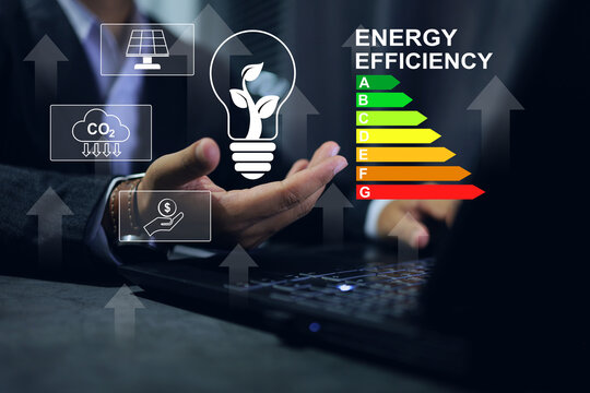 A man save earth by choosen  an electric light bulb with tree inside and an energy saving rating sign to tell every one the value of the product to make a decision. Energy saving and zero co2