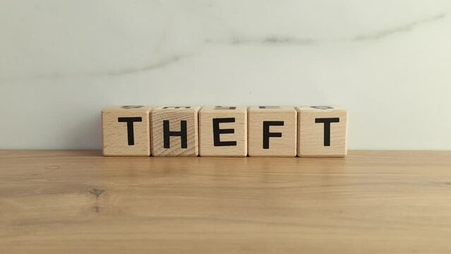 Word theft from wooden blocks. Crime, steal concept