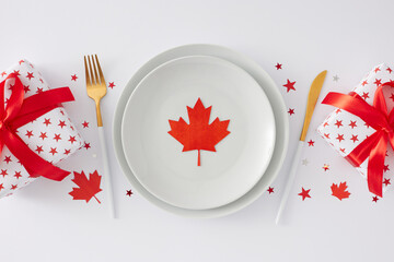 Make a statement with your table decor on July 1st Canada Day. Top view flat lay of white plates,...