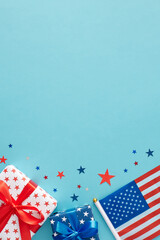 Obraz premium America's Independence Day festivities concept. Top view flat lay of national flag, gift boxes, stars on light blue background with space for text or ads