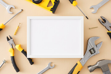 Design concept of hand tools for repair. Top view flat lay of basic tool set on light beige background with empty frame for text or promo