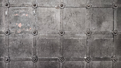 Grunge black metal background with symmetrically arranged trim strips. Square grid finish and...