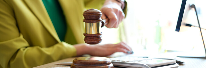 Woman hand striking with judge gavel in court room