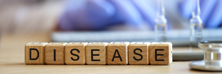 Word disease made of wooden blocks in raw on table