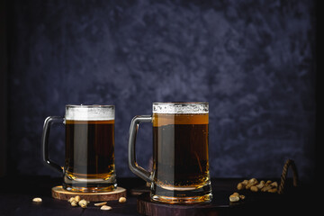 Beer glasses with lager, dark lager, brown ale, malt and stout beer on table, dark wooden background