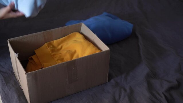 Woman donates her clothes. Sale of used clothes. Donation