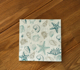 Napkin with sea shells and stars on the table viewed from above - obrazy, fototapety, plakaty