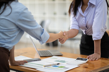 Fototapeta premium Recruiter shaking hands with a young female candidate after a job interview.