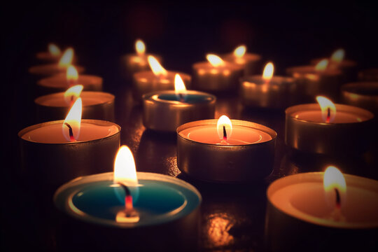 A collection of illuminated candles resting upon a table's surface.
