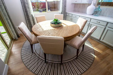 Dining Area With Round Table And Six High Back Chairs